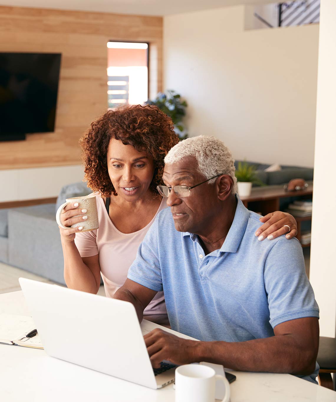 couple sitting at kitchen table with laptop income for life