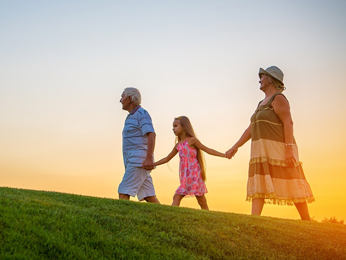 grandparents walking hand in hand with granddaughter at sunset what is an iul