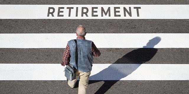 above view of senior man walking on street toward the word retirement contact
